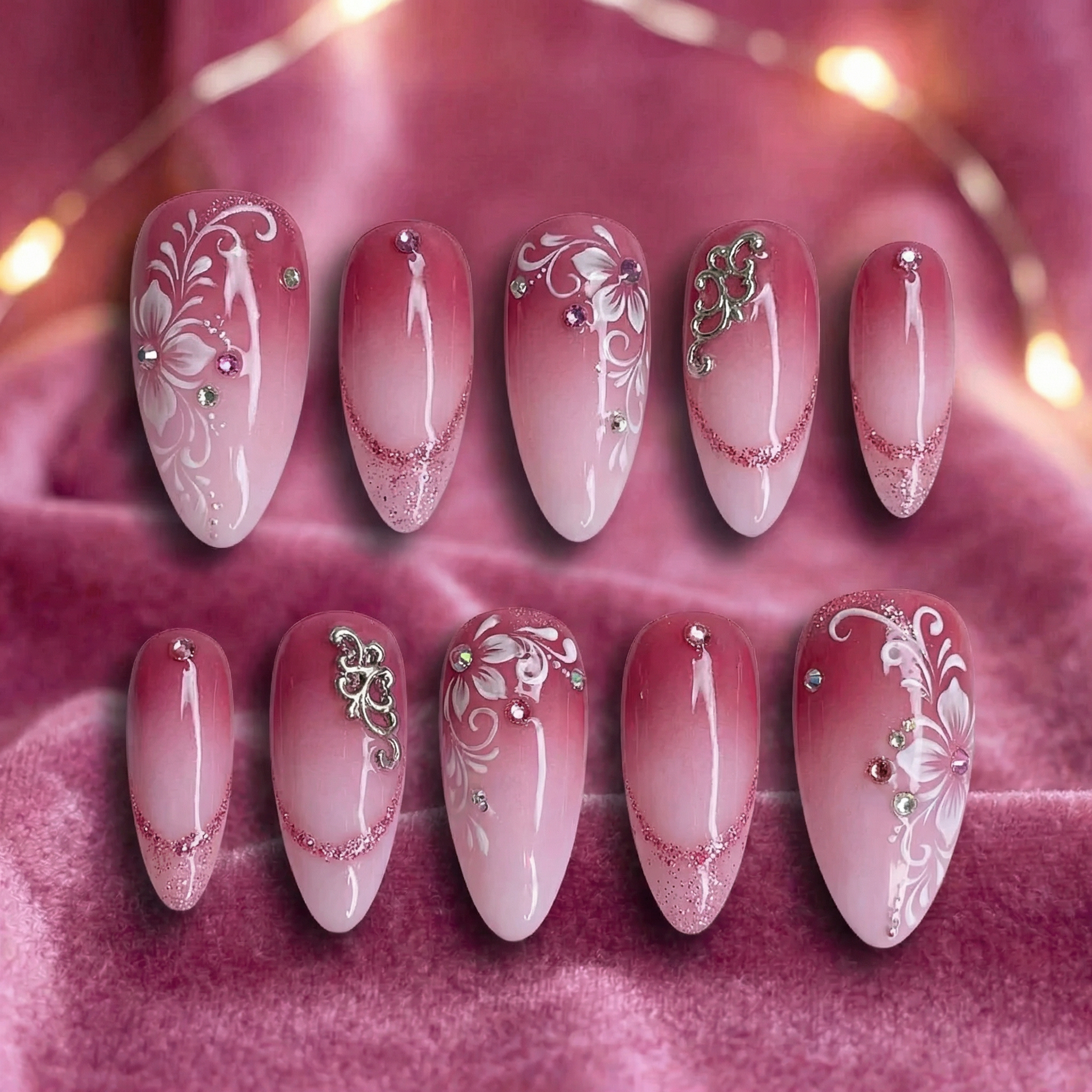 Pink press-on nail flat lay - ombre design with rhinestone accents before AI processing